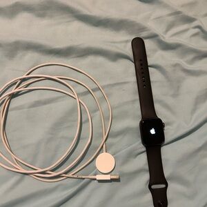Apple Black Smartwatch with White Magnetic Charger Cable